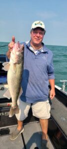 Picture of Len Julio holding a large fish he caught